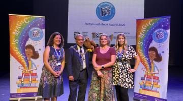 Author and city mayor with library staff