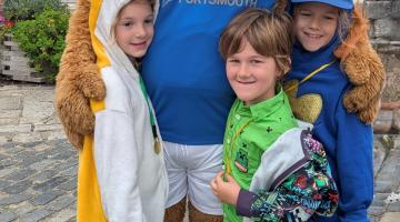 3 children and a bear in costume