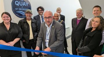 Group gathered for a ribbon-cutting at The Quay at St George’s.