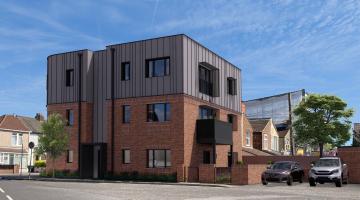 Mock up image of a new building that will be built in place of the knocked down buildings