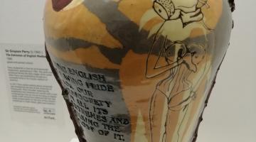 Ceramic vase yellowish in colour on display in museum