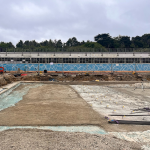Hilsea Lido. Shallow end. Changing rooms and trees behind.