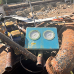 Broken pipes. Old dial from plant room.