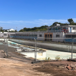 Hilsea Lido. Empty pool. Metal fencing.