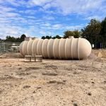 Backwash tank; Beige. Torpedo shaped. 10m long.