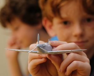 Boy holding Airfix model plane