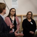 A group of people listening to a male speaker at the social value workshop