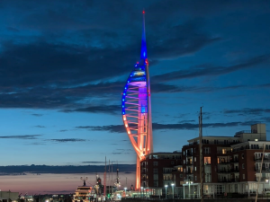 Spinnaker Tower at dusk lit up in Foster Portsmouth brand blue and orange