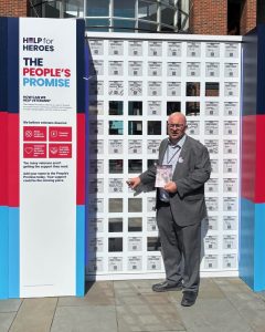 Council leader Steve Pitt adding his name to the Peace Puzzle