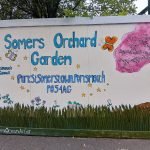 painted mural outside Somers Orchard community garden reading 'Somers Orchard garden'