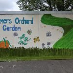 painted mural outside Somers Orchard community garden