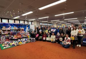 The companies who donated the gifts alongside the community groups who will distribute them to families.