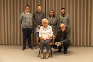 Young people pictured with Chris, who they interviewed about her experiences during Second World War