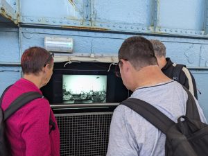 Community group members exploring the landing craft at the museum.