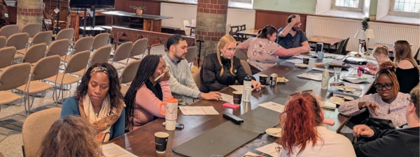 Community researchers having a discussion around a table